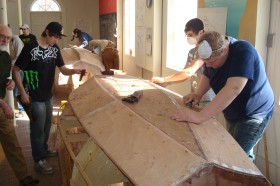 Searsport District High School Students working on a Shellback dinghy at PMM