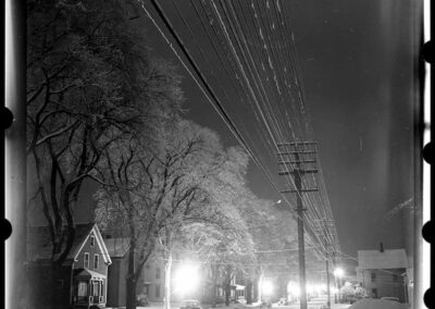 Returning from eight months overseas, Kosti settled in the Dodge Mountain dwelling his father built when the family moved from Vermont. In the winter of 1949 he made photographs at night that are unique and surreal. He found the Park Street scene nearby in Rockland following a snow and ice storm. He later titled the image “Winter lace”. It became one of a number selected as the essay: “Winter Night Evokes Poets’ Praises.” LIFE February 26, 1951 & Greatest Essays from LIFE Magazine, 1978